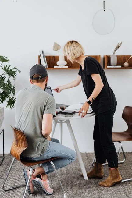 A stylish workspace featuring a laptop and monitors displaying design software.